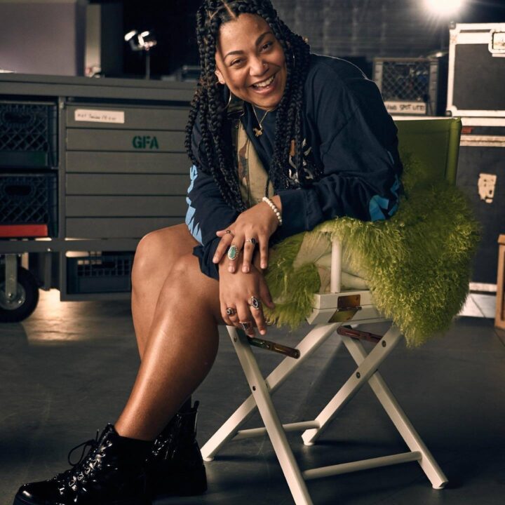 Full-body picture of Kayla Elise Thomas sitting in a folding chair